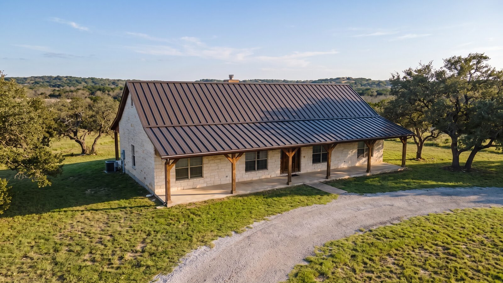 The same house after installation of a dark bronze 24-gauge standing seam metal roof